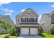 Two-story home showcasing a two-car garage, brick accents, and a well-manicured lawn at 1022 Homecoming Way, Durham, NC 27703