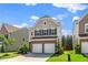 Charming two-story home featuring a two-car garage, brick accents, and a cozy front yard at 1022 Homecoming Way, Durham, NC 27703