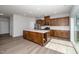 Bright kitchen with stainless steel appliances, a large island, and wood cabinets at 1022 Homecoming Way, Durham, NC 27703