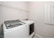 Bright laundry room with a modern washer and dryer and wire shelving above at 1022 Homecoming Way, Durham, NC 27703