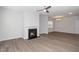 Living room featuring a modern fireplace, ceiling fan, and chandelier in the dining area at 1022 Homecoming Way, Durham, NC 27703