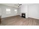 Bright living room featuring a ceiling fan, fireplace, and modern flooring at 1022 Homecoming Way, Durham, NC 27703
