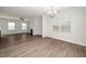 Bright, open-concept living room with a fireplace and modern wood-look flooring at 1022 Homecoming Way, Durham, NC 27703