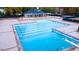 Aerial view of a swimming pool with lane markers, surrounded by concrete deck and trees at 105 Abbotsford Ct, Durham, NC 27712