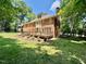 Large backyard with a multi-level deck and a well-maintained lawn, perfect for outdoor activities at 105 Abbotsford Ct, Durham, NC 27712
