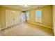 Spacious bedroom with carpeted floors, ample closet space, and natural light at 105 Abbotsford Ct, Durham, NC 27712