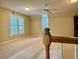 The spacious bonus room has carpet and a ceiling fan at 105 Abbotsford Ct, Durham, NC 27712