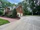 Lovely brick two-story home featuring a two-car garage, well maintained shrubbery and pristine driveway at 105 Abbotsford Ct, Durham, NC 27712