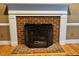 Close up of fireplace with brick surround and black metal screen at 105 Abbotsford Ct, Durham, NC 27712