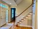 Welcoming foyer with hardwood floors, staircase, and front door at 105 Abbotsford Ct, Durham, NC 27712