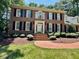 Attractive brick home with symmetrical windows and manicured landscaping at 105 Abbotsford Ct, Durham, NC 27712