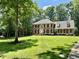 Traditional brick home with a well-manicured lawn and mature trees at 105 Abbotsford Ct, Durham, NC 27712