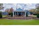 Stately home with manicured front lawn, stone retaining wall and covered front porch at 105 Abbotsford Ct, Durham, NC 27712