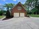 Detached garage with two bays and ample parking space, nestled in a landscaped backyard at 105 Abbotsford Ct, Durham, NC 27712