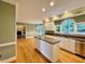 Bright kitchen features an island with granite counters, white cabinets, and stainless steel appliances at 105 Abbotsford Ct, Durham, NC 27712