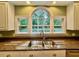 Kitchen with a stainless steel sink, granite countertops, and view to the backyard at 105 Abbotsford Ct, Durham, NC 27712