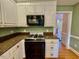 Bright kitchen features countertops, white cabinets, and stainless steel appliances at 105 Abbotsford Ct, Durham, NC 27712