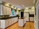 Bright kitchen features white cabinetry, stainless appliances and granite countertops at 105 Abbotsford Ct, Durham, NC 27712