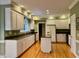 Bright kitchen features white cabinetry, stainless appliances and granite countertops at 105 Abbotsford Ct, Durham, NC 27712