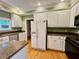 Bright kitchen features an island with granite counters, white cabinets, and stainless steel appliances at 105 Abbotsford Ct, Durham, NC 27712