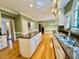 Spacious kitchen with hardwood floors, island, and granite countertops at 105 Abbotsford Ct, Durham, NC 27712