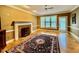 Bright living room with hardwood floors, fireplace, and large windows at 105 Abbotsford Ct, Durham, NC 27712