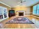 Spacious living room with hardwood floors, fireplace, and a large area rug at 105 Abbotsford Ct, Durham, NC 27712