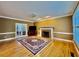 Inviting living room features hardwood floors, a fireplace, and lots of natural light at 105 Abbotsford Ct, Durham, NC 27712