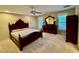 Main bedroom showcasing a dark wood furniture set, plush carpet, and a well-lit ceiling fan at 105 Abbotsford Ct, Durham, NC 27712