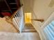 Carpeted staircase with wood banister leads to the next level at 105 Abbotsford Ct, Durham, NC 27712