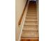 Carpeted staircase with wooden handrail and white trim at 105 Abbotsford Ct, Durham, NC 27712