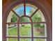 Bright, arched window with views of the lush, landscaped yard, offering plenty of natural light at 105 Abbotsford Ct, Durham, NC 27712