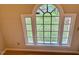 Arched window with a view of the green lawn at 105 Abbotsford Ct, Durham, NC 27712