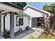 Charming exterior of the home shows white siding, dark trim, and a yard with plants and flowers at 1103 S Bloodworth St, Raleigh, NC 27601