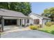 Charming exterior with white siding, dark trim, a well-kept lawn and a driveway with carport at 1103 S Bloodworth St, Raleigh, NC 27601