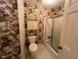 Bathroom with floral wallpaper, vanity, toilet and shower with tub at 1116 Friendly Rd, Dunn, NC 28334