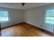 Bedroom with natural light from two windows and hardwood floors at 1116 Friendly Rd, Dunn, NC 28334