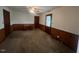 Spacious carpeted bedroom featuring a ceiling fan and a wooden desk at 1116 Friendly Rd, Dunn, NC 28334