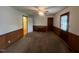 Bright bedroom featuring paneled walls, a ceiling fan, and a built-in desk at 1116 Friendly Rd, Dunn, NC 28334