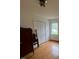 Bedroom with hardwood floors, closet, and natural light from the window at 1116 Friendly Rd, Dunn, NC 28334