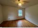 Bright bedroom features hardwood floors, a ceiling fan, and natural light from the window at 1116 Friendly Rd, Dunn, NC 28334