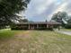 Charming single-story brick home with a well-maintained lawn and mature trees at 1116 Friendly Rd, Dunn, NC 28334