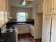 Well-lit kitchen with white cabinets, updated appliances, and a window over the sink at 1116 Friendly Rd, Dunn, NC 28334