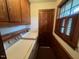 Practical laundry room with washer, dryer, and ample cabinet storage at 1116 Friendly Rd, Dunn, NC 28334