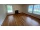 Spacious living room featuring hardwood floors, a fireplace, and lots of natural light at 1116 Friendly Rd, Dunn, NC 28334