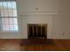 Cozy living room featuring a classic brick fireplace and large windows at 1116 Friendly Rd, Dunn, NC 28334