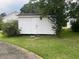 Exterior view of a well-maintained white storage shed with double doors at 1116 Friendly Rd, Dunn, NC 28334