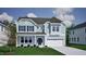 Charming two-story home with blue siding, black shutters, well-manicured lawn, and attached garage at 115 Guardian St, Youngsville, NC 27596