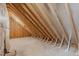Unfinished attic space with exposed rafters and a concrete slab floor at 116 Pointe Park Cir, Holly Springs, NC 27540
