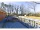 Long wooden deck of a home, offering ample outdoor space and backyard view with utility shed at 1186 Dick Holeman Rd, Timberlake, NC 27583